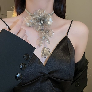 Macro shot of tiered silver flower choker with intricate metallic mesh petals on a model