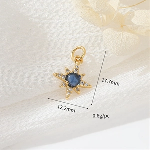 Macro detail of 14k gold star pendant with blue gemstone and dimensions 17.7mm x 12.2mm