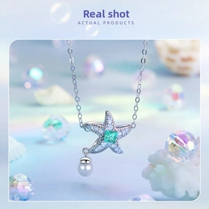 Macro view of ocean star silver pendant with blue stones and a hanging pearl