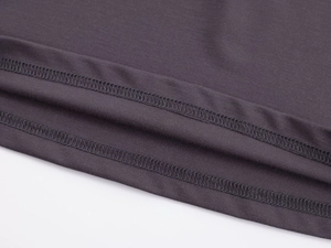 Close-up of double-stitched hem and fabric texture on a slim fit long sleeve sports top