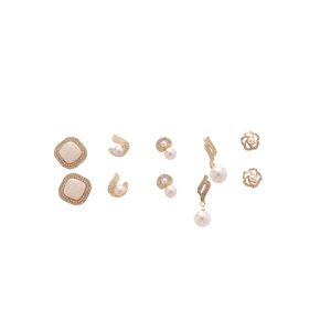 Set of 5 gold earrings with shimmering rhinestones and elegant pearls on white background