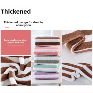 Detail view of thickened striped coral fleece towel showing soft texture and high absorption
