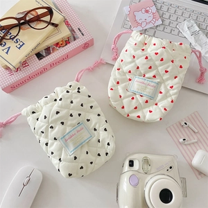 Quilted cotton camera pouch with heart patterns, drawstring closure, and soft protective texture