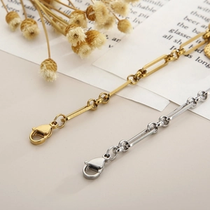 Detail of gold and silver stainless steel chain link bracelet with lobster clasp