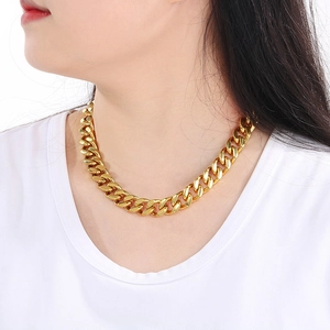 Detail of 13mm gold cuban link necklace with dragon clasp shown on a male model