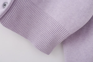 Detailed close-up of lavender knit fabric texture and high-quality dark grey button