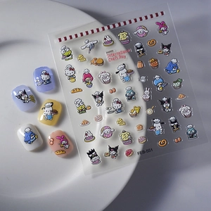 Detail showing Sanrio chef themed nail stickers and 5 applied fake nails on a plate