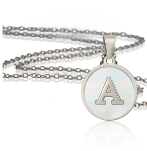 Detailed macro view of silver stainless steel pendant necklace with letter A and shell inlay