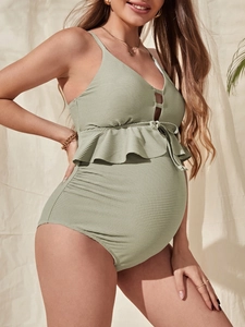 Sage green maternity one-piece swimsuit with ruffle trim and textured ribbed fabric