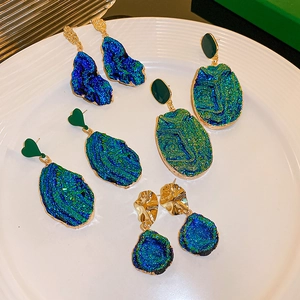 Detailed set of vintage blue and gold geometric earrings with textured heart designs