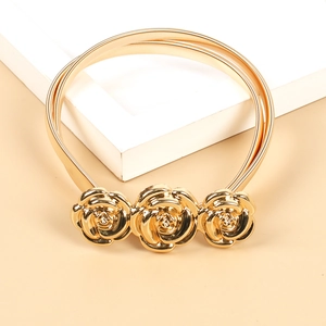 Detailed close-up of a gold metal spring waist belt featuring three rose flower buckles
