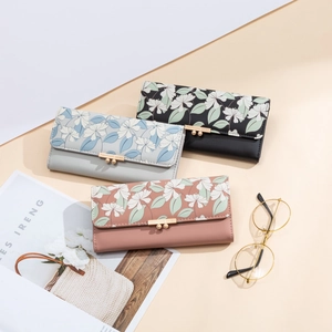 Three long floral wallets in black, blue and pink with gold metal buckles for women