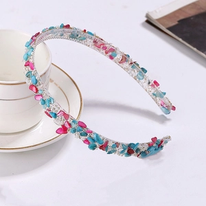 Detail of floral crystal headband with blue and rose stones plus white pearls on clear base