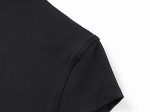Close-up of high-elastic knit stitching on the shoulder of a black slim-fit sports T-shirt