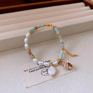 Macro view of freshwater pearl and seashell pendant necklace with beach vacation style