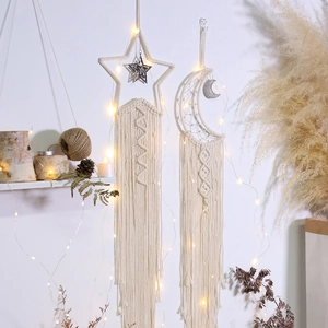 Detailed close-up of handmade macrame star and moon wall decor with LED fairy lights
