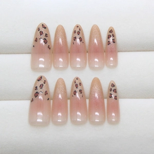 Almond shaped press-on nails with nude pink gradient and stylish leopard print patterns