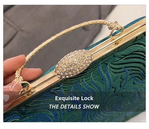Close-up of vintage kiss-lock buckle with white rhinestones on green jacquard handbag