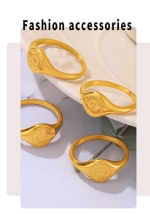Detailed close-up of 18k gold plated sunflower rings on white ceramic and leaf
