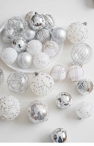 Detail of silver and white Christmas ornaments with glitter patterns and pearl textures