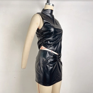 Detail of black PU leather set featuring sleeveless stand collar top and ruched bodycon skirt