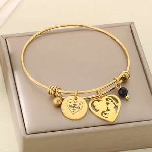 Close-up of golden adjustable MOM bracelet with Happy Mother's Day engraved charms