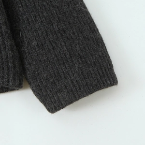 Detailed close-up of charcoal grey knitted sweater cuffs with ribbed texture and thick yarn
