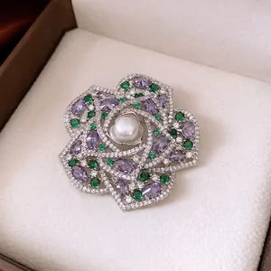 Vintage flower brooch with pearl center, purple and green zircons in hollow metal frame