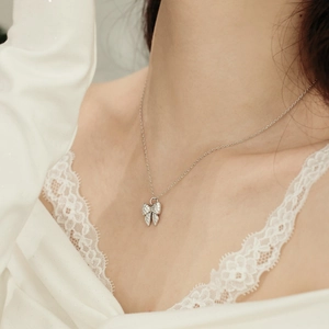 Close-up of S925 sterling silver butterfly necklace with zircon on female model