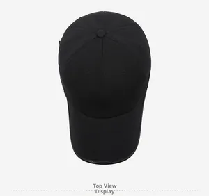 Top view of a black cotton baseball cap with premium leather piping on the curved brim