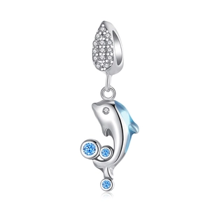 Detailed view of silver dolphin charm featuring blue enamel and sparkling crystal stones