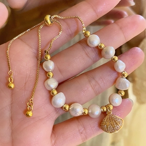 Baroque freshwater pearl bracelet with gold shell pendant and adjustable pull chain