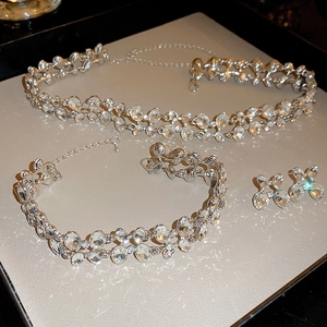 Elegant silver butterfly jewelry set with sparkling rhinestones on beige display pad