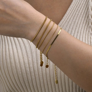 5-piece gold titanium steel layering bracelet set with snake and box chains on wrist