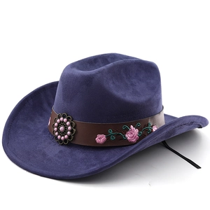 Detail of western cowboy hat featuring rose embroidery and decorative bronze buckle