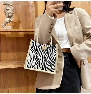 Detail of zebra pattern canvas tote with wooden clasp and natural hemp rope handle