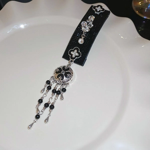 Close-up of retro velvet hairband with silver floral rhinestones and fringe tassels
