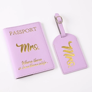 Close-up of purple faux leather passport holder and luggage tag with gold Mrs. engraving