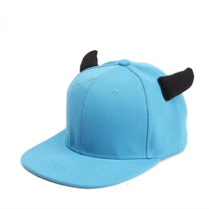 Detail of light blue flat brim cap with 3D black devil horns and cotton twill texture