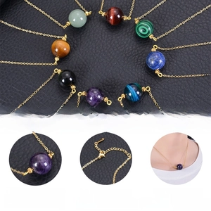 Detailed view of natural crystal stone pendant and the adjustable gold-tone extender chain