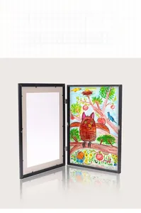 Detail of black hinged art frame showing internal storage and display for children's art