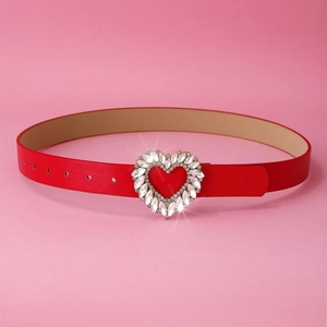 Close-up of red leather belt featuring a sparkling heart buckle with clear rhinestones