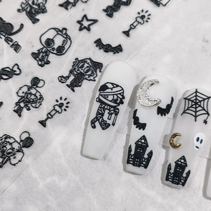 5D Halloween nail stickers with black mummy, bat and pumpkin designs on white nails