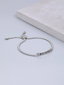 Minimalist silver stainless steel bracelet featuring an engraved BELIEVE metal plate
