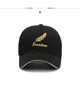 Detailed front view of black cotton baseball cap with gold feather and Freedom embroidery