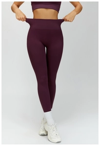 Detail of high-waist yoga pants showing elastic compression and seamless fabric texture