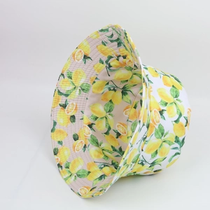 Detail of yellow lemon pattern print on a vintage style double-sided cotton bucket hat