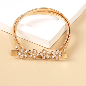 Detail der goldenen elastischen Metall-Taillenkette mit Perlenblumen und kleinen Strass