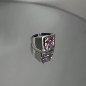 Minimalist wide band open ring featuring a large emerald cut pink zircon stone