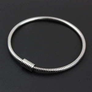 Close-up of polished silver stainless steel snake chain bracelet with cylindrical clasp